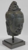 A Southeast Asian carved hardstone head of Vishnu with serene face, open eyes, elongated earlobes,