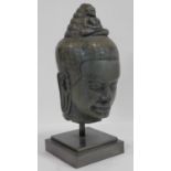 A Southeast Asian carved hardstone head of Vishnu with serene face, open eyes, elongated earlobes,