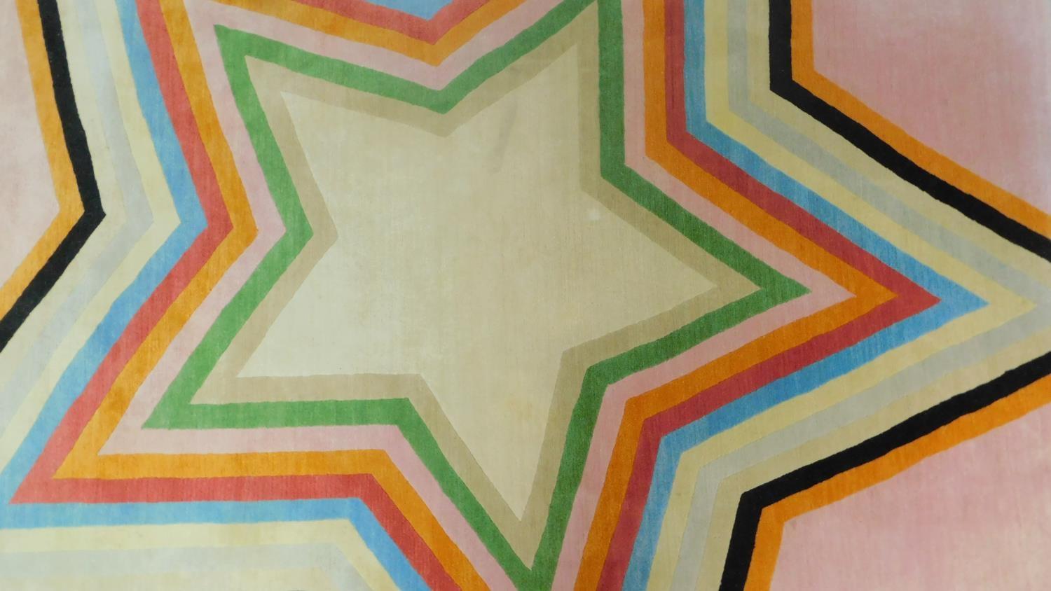 Paul Smith; handmade for the Rug Company, a carpet with large multi-coloured central star motif on