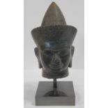 A Southeast Asian carved hardstone head of Vishnu with serene face, open eyes, elongated earlobes,
