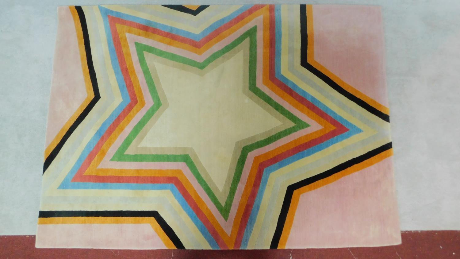 Paul Smith; handmade for the Rug Company, a carpet with large multi-coloured central star motif on - Image 2 of 4