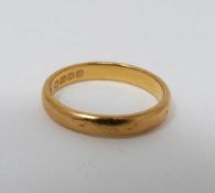 An Art Deco 22 carat yellow gold engraved D-shaped wedding band. Hallmarked BlBs for Bendall