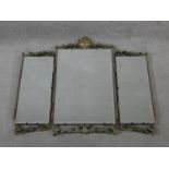 A mid century vintage triple section dressing mirror with painted and carved scrolling foliate frame