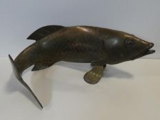 A Chinese stylised brass cast figure of a carp swimming. H.26xW.60cm