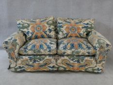 A two seater sofa in polychrome Chinoiserie upholstery. H.76xW.173xL.93cm