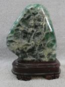 A large polished Fluorite crystal boulder mounted on a carved Chinese wooden stand. H.31cm