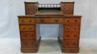 A 19th century mahogany Dicken's type pedestal desk with raised fitted superstructure with tooled