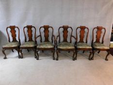 A set of six early Georgian style figured mahogany dining chairs with vase shaped splats above