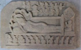 A carved sandstone Southeast Asian frieze of a reclining figure of Vishnu on serpent Anata