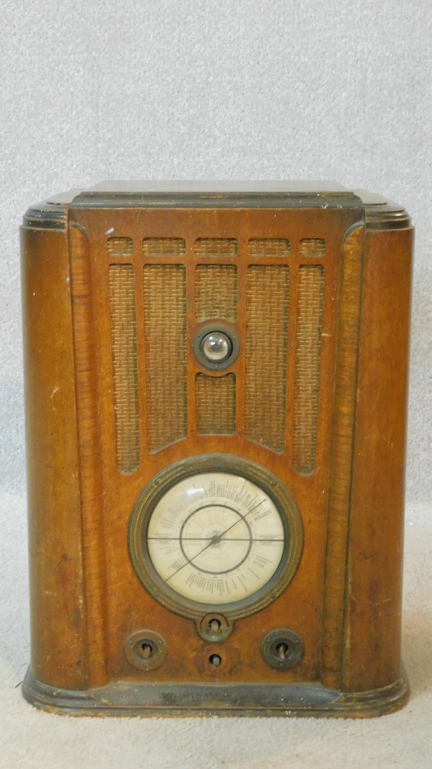 A vintage Pilot Radio Ltd valve radio in burr walnut Art Deco case. H.50 W.39 D.28cm