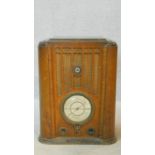 A vintage Pilot Radio Ltd valve radio in burr walnut Art Deco case. H.50 W.39 D.28cm