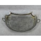 A large silver plated two handled tray with a repousse design border with oval cartouches of putti