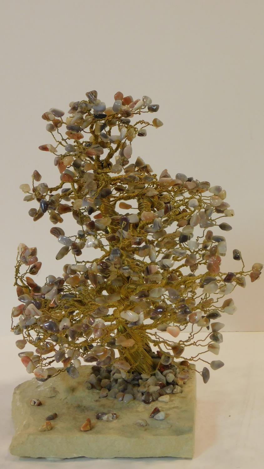 A vintage brass and agate tree on a stone slab base. The leaves are each chips of various coloured