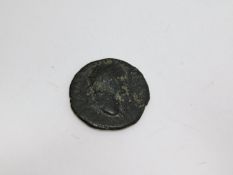An ancient bronze Roman coin with a winged figure on one side and Roman male bust on the other. D.