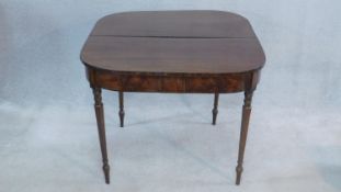 A 19th century flame mahogany tea table with fold over top on turned tapering supports. H.74 W.91cm