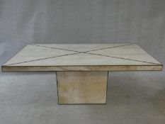 A brass bound travertine marble dining table on pedestal base. H.74xW.181xL.90cm