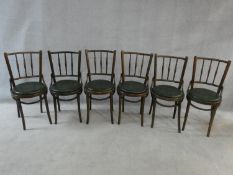 A set of six bentwood café style dining chairs with spindle backs and undulating hoop stretchered