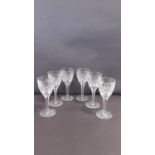 A set of six star cut heavy lead crystal small sherry glasses with star cut design to bases and