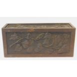 A late 19th century oak stationery casket with Arts and Crafts style floral carved panels. H.22 W.50