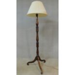 An early 20th century mahogany standard lamp with turned column on tripod cabriole supports. H.184cm