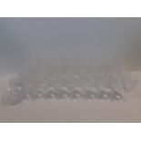 A collection of heavy hand cut star design lead crystal glasses and plates; eight medium wine