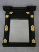 A Regency ebonised pier mirror with original plate flanked by columns with gilt acanthus carved