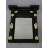 A Regency ebonised pier mirror with original plate flanked by columns with gilt acanthus carved