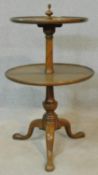 A 19th century mahogany two tier dumb waiter with turned finial to the top and central column on
