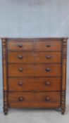 A Victorian mahogany chest of two short over four long drawers flanked by pilasters on turned