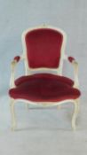 A white painted Louis XV style open armchair in burgundy velour upholstery. H.86cm