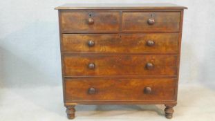A 19th century figured mahogany chest of two short over three long drawers on turned supports. H.108