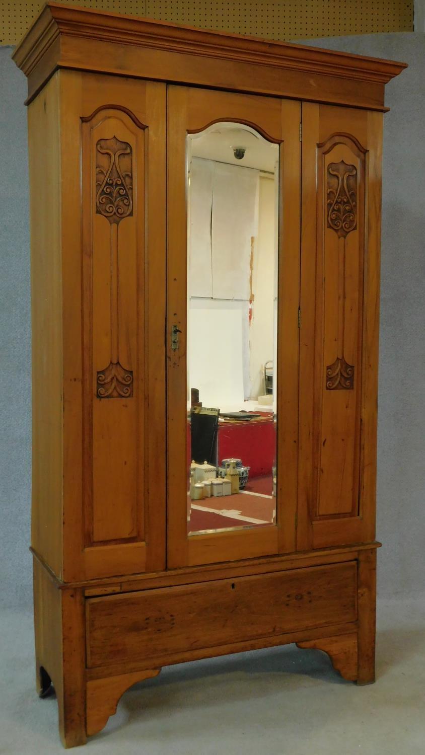 A late 19th century satin walnut wardrobe with central shaped bevelled mirror door flanked by Art - Image 2 of 9