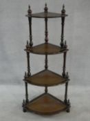 A Georgian style mahogany four tier corner whatnot with inset leather tops. H.122xW.59xL.43cm
