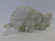 A large carved Chinese Jade bull sculpture with engraved floral motifs. L.35cm