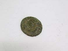 A ancient Roman coin with warrior figure on one side and bust on the other. D.1,6cm