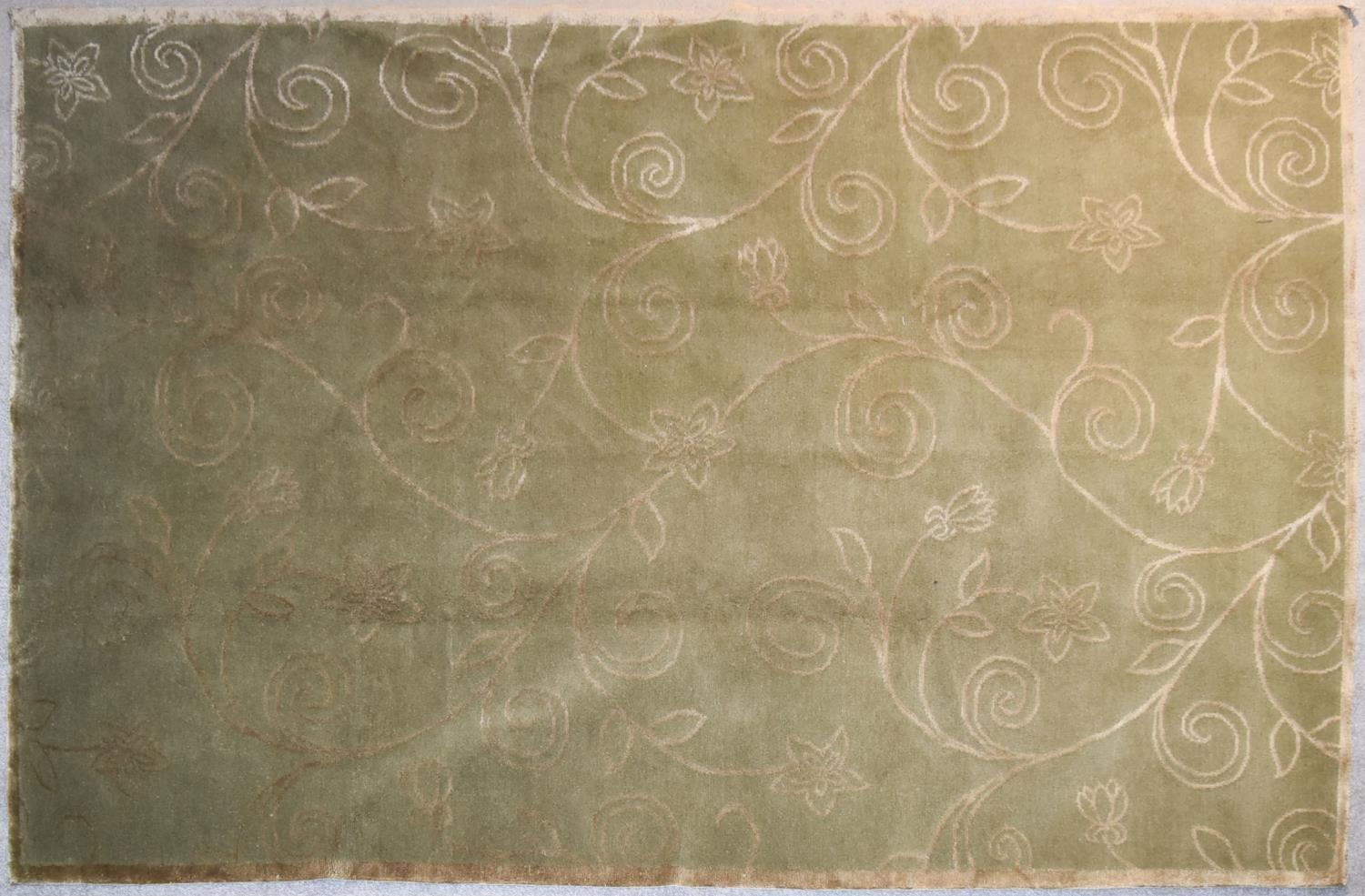 A silk and wool rug with allover scrolling foliate and flowerhead design on a taupe background. L.