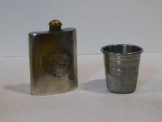 A novelty English pewter thimble form cup engraved 'Just a Thimble Full' along with a silver
