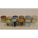 A collection of eleven porcelain hand painted antique coffee cups, all with various designs and some