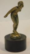 A 1920/1930's brass car mascot in the form of a female bather about to dive mounted on an ebonised