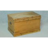 A 19th century pine trunk with hinged lid and side carrying handles. H.42 W.46 D.27cm (largest)