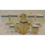 A collection of German blue and white vintage food storage jars and matching oil bottle. Each with