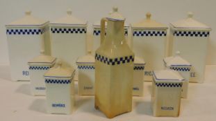 A collection of German blue and white vintage food storage jars and matching oil bottle. Each with