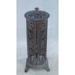 A 19th century style wrought iron greenhouse heater case with allover pierced scrolling