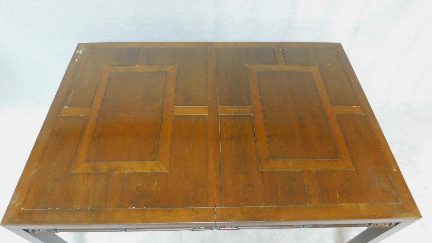 A Chinese hardwood extending dining table with parquetry top above carved frieze on square - Image 3 of 6
