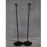 A pair of metal floor standing uplighters with opaque shades. H.133cm