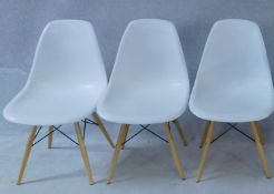 Three Eames style moulded tub chairs. H.80cm