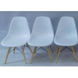 Three Eames style moulded tub chairs. H.80cm