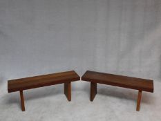 A pair of African hardwood benches with planked tops on block trestle supports. H.47 W.104 D.42cm