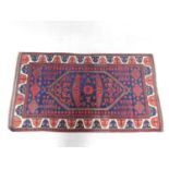 A Persian rug with central lozenge medallion and allover floral motifs on a sapphire ground