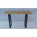 An Eastern hardwood planked top console table on wrought metal base. H.80 W.120 D.36cm